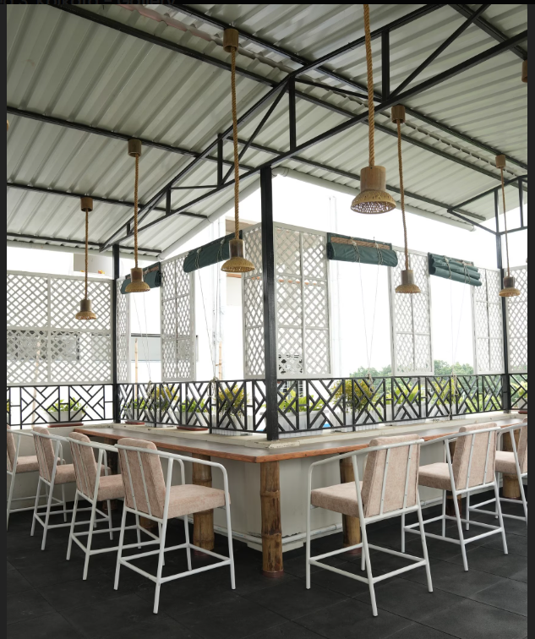 Cafe fully furnished: bamboo lamps, lattice screens, wooden tables, white chairs