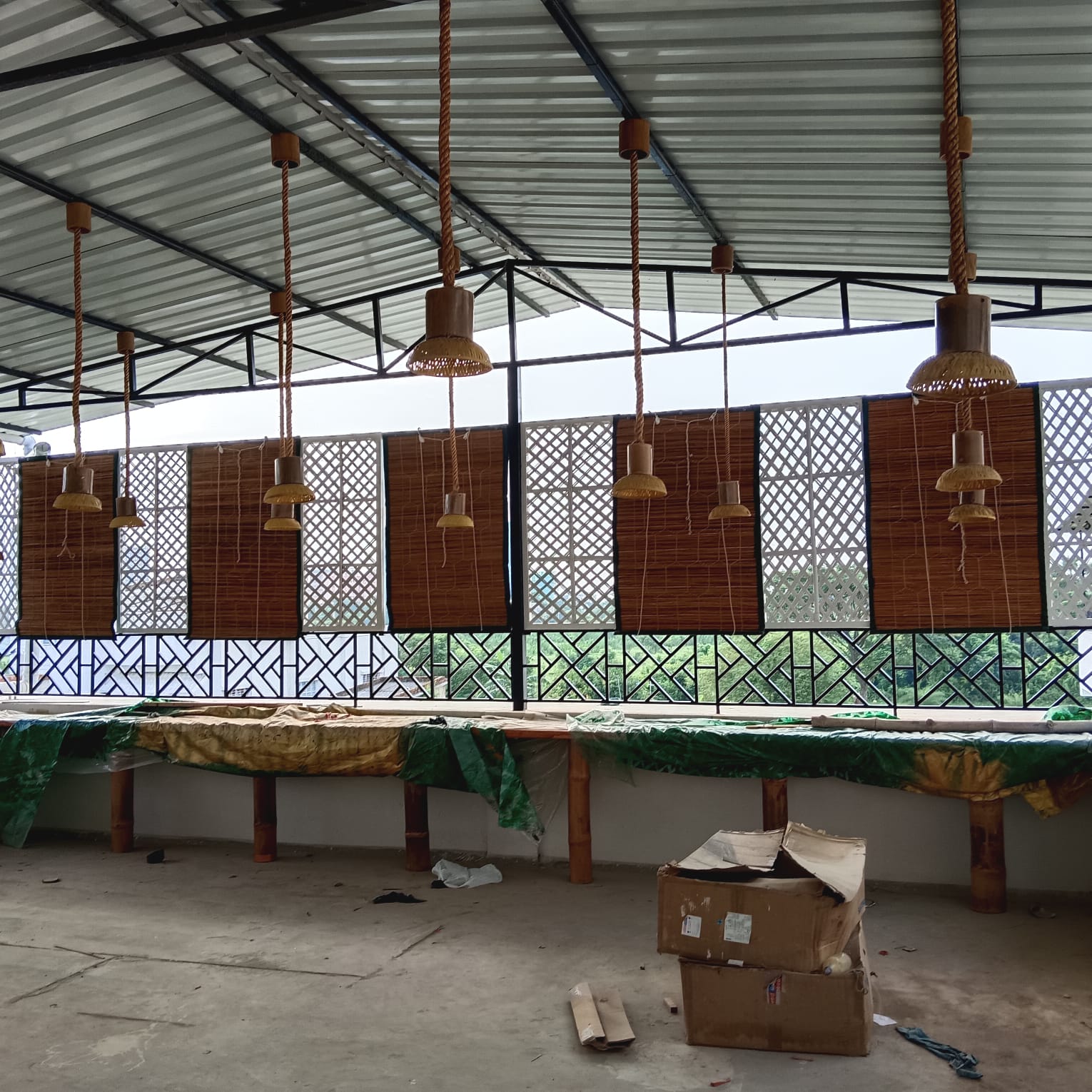Bamboo pendant lamps and cane blinds in cafe
