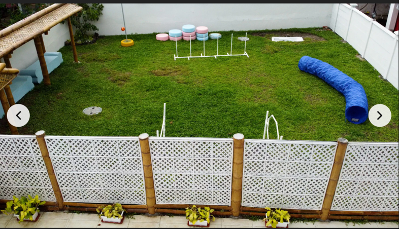 Play area: green lawn, tyre tunnels, bamboo lattice fencing