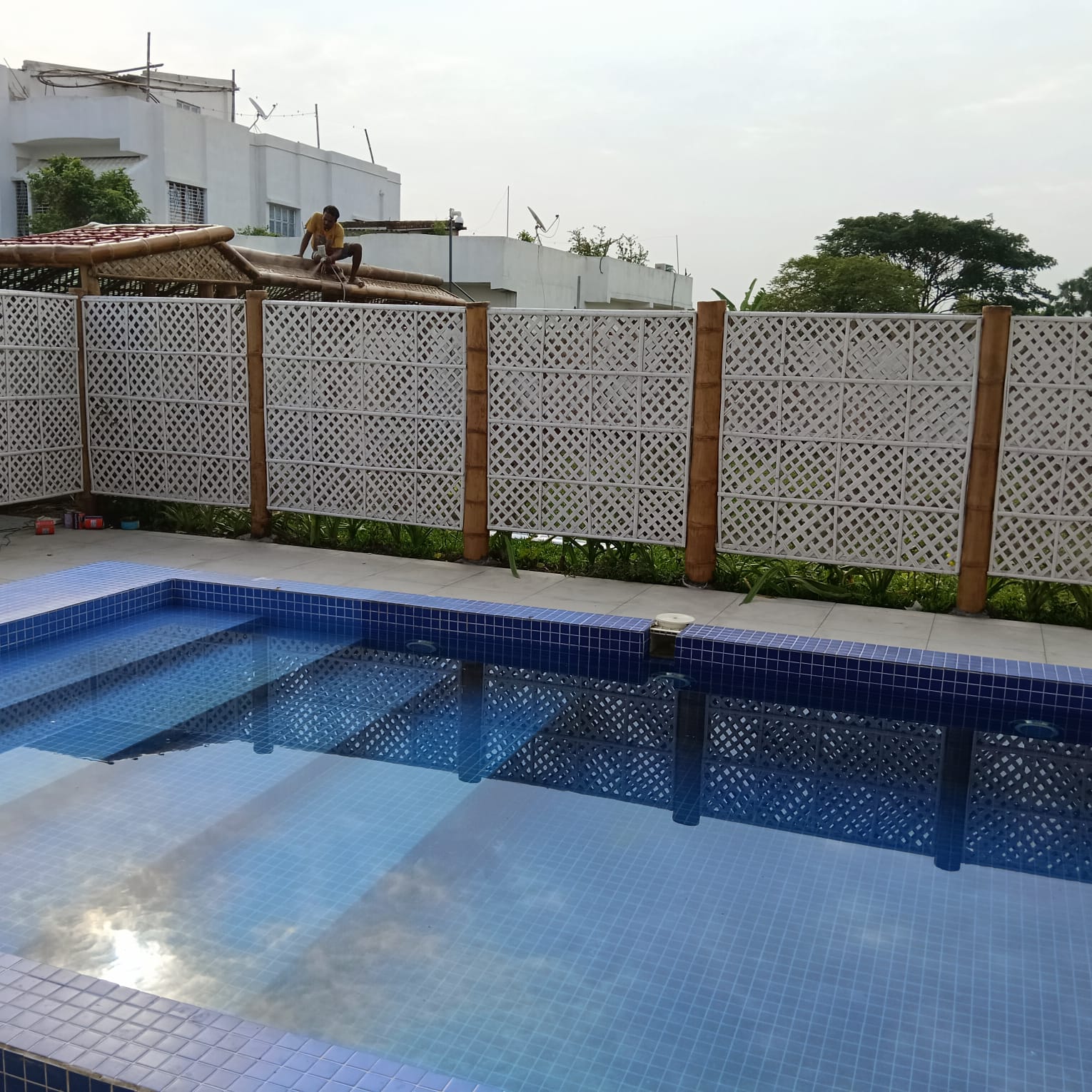 Pool wider angle showing karigar on pergola structure