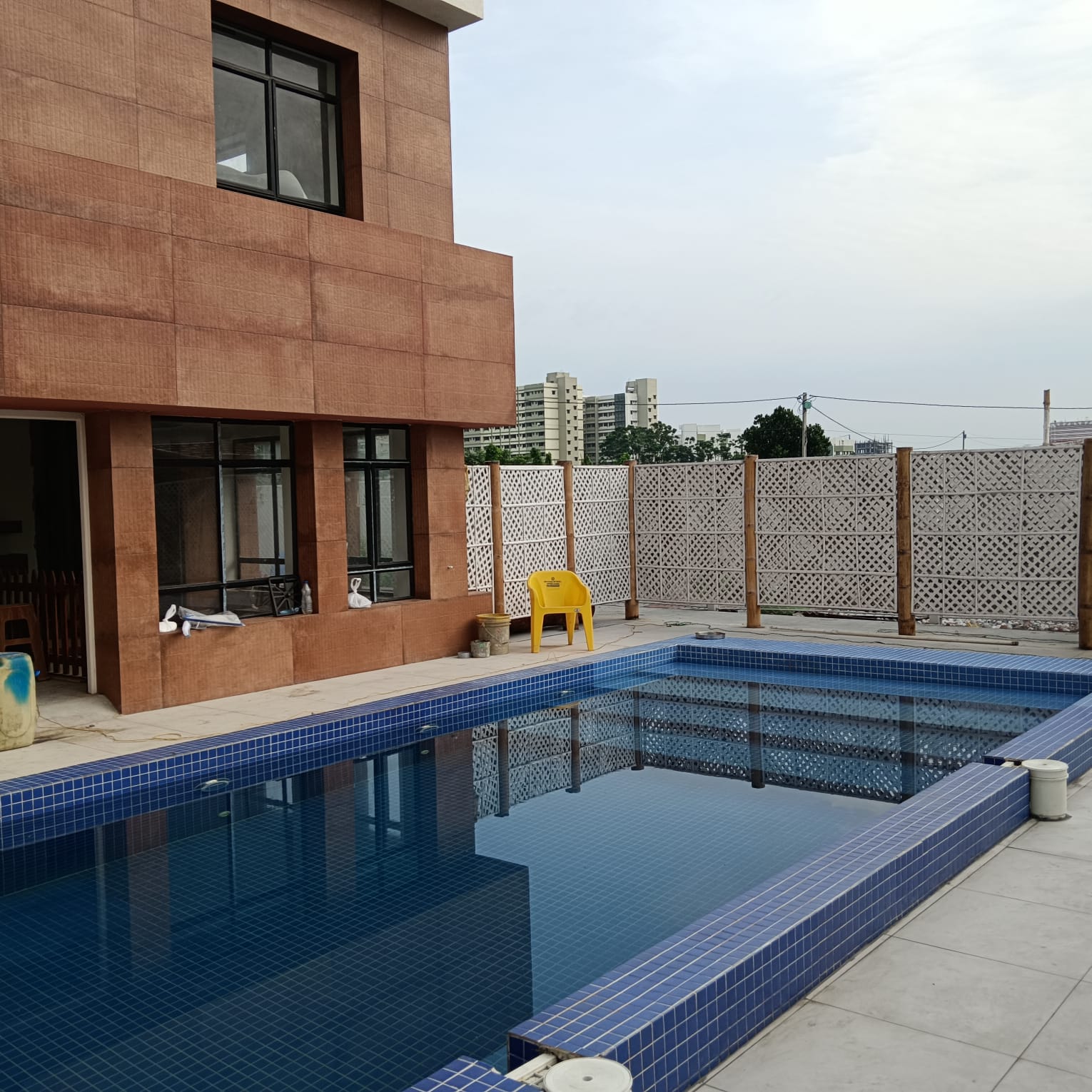 Pool during construction: blue tiles, bare surroundings